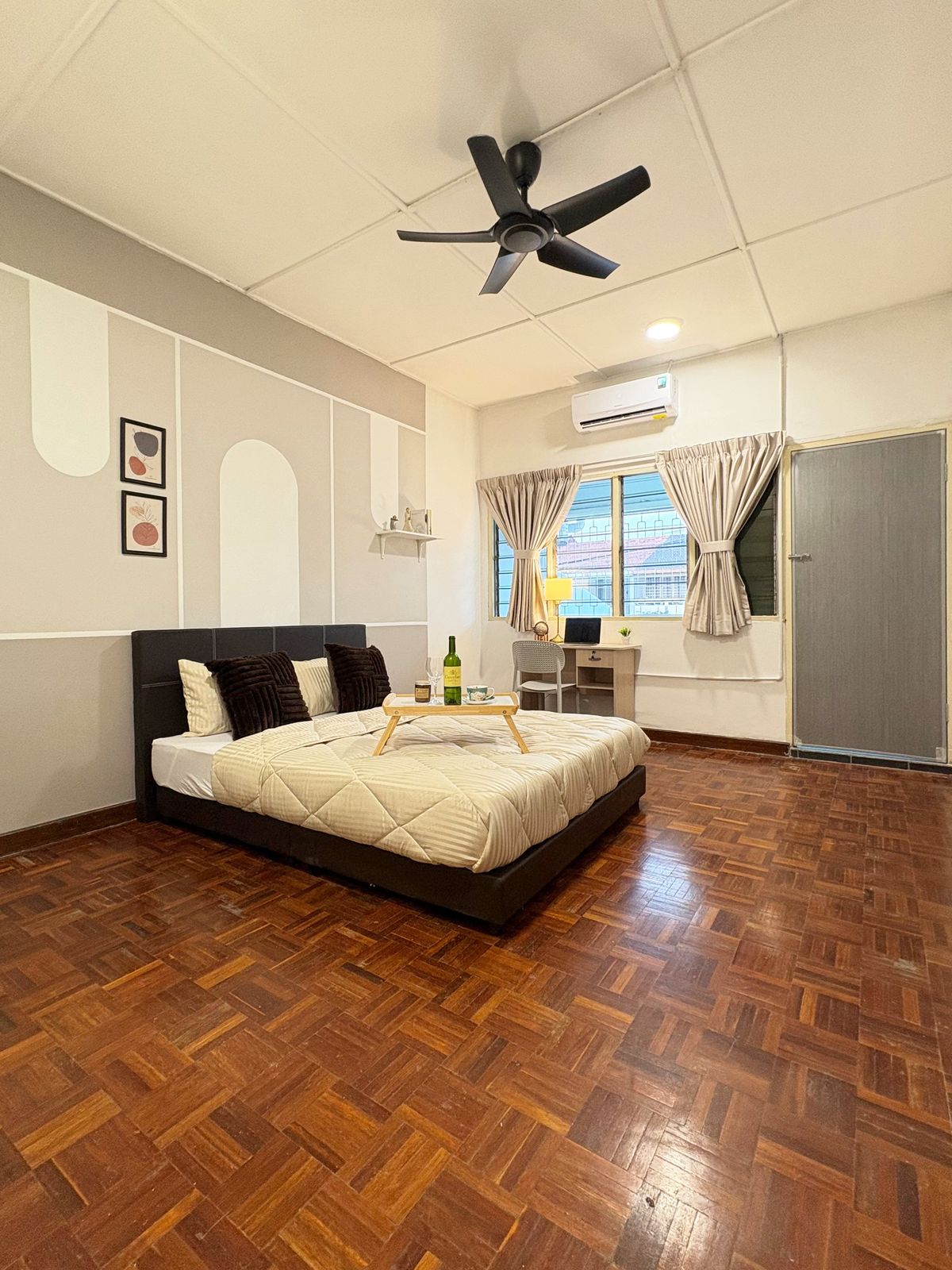 Master bedroom with a queen bed, study desk, and parquet floor