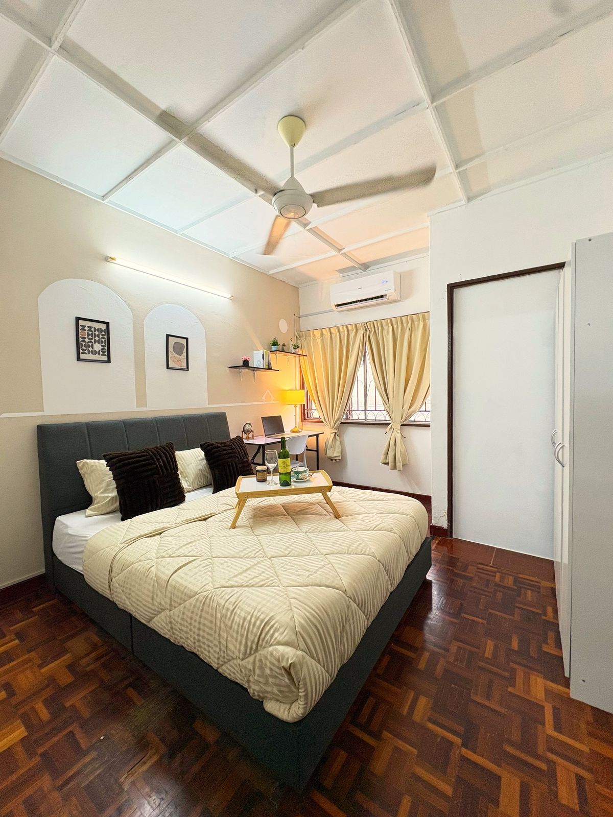 Master bedroom with a grey upholstered bed and wardrobe