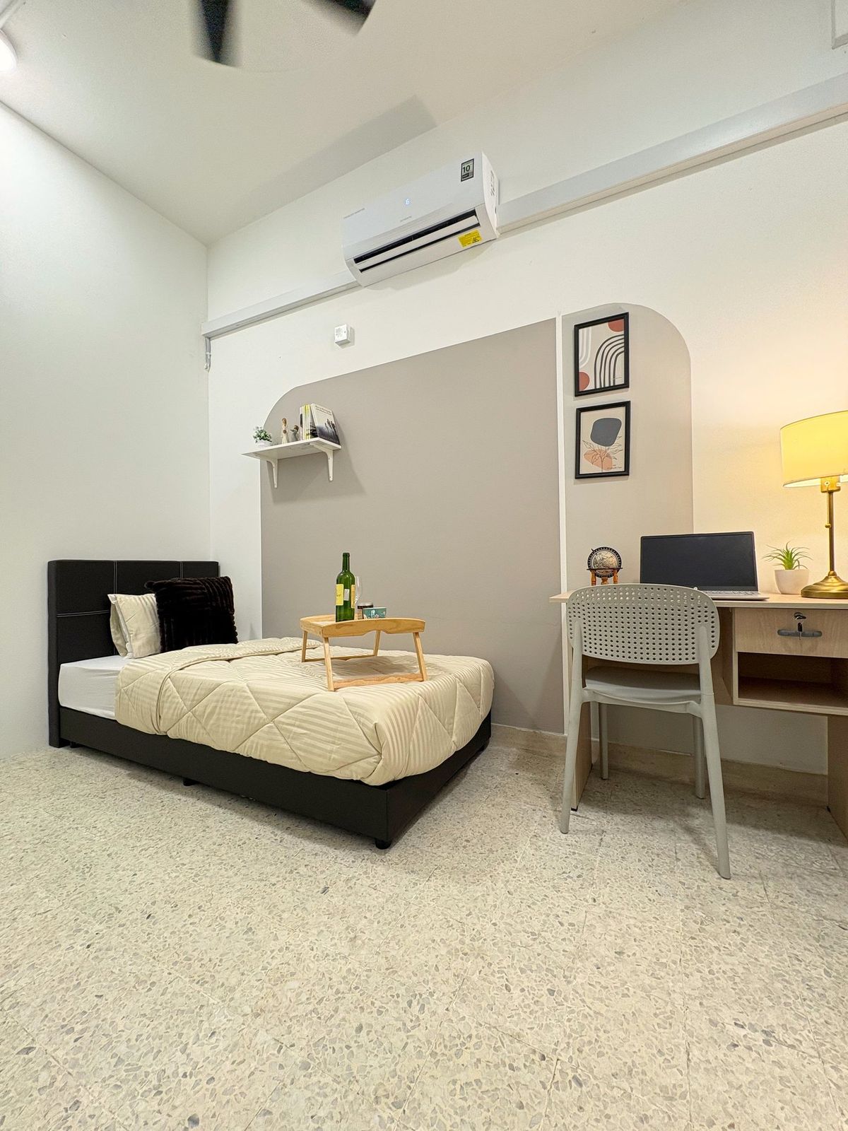 Furnished Myroomzie bedroom with a single bed, study desk, air conditioning, and framed prints