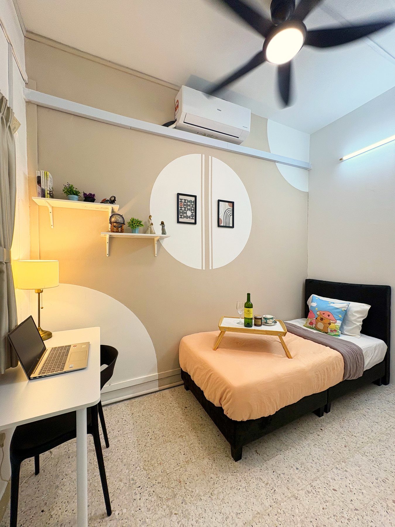 A fully furnished private bedroom in a Myroomzie co-living home, with a bed, desk, and warm lighting